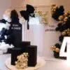 Gold and black balloon backdrop with Tony's 40th birthday custom signage