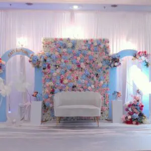 Luxury floral baby shower backdrop with pastel theme and couch