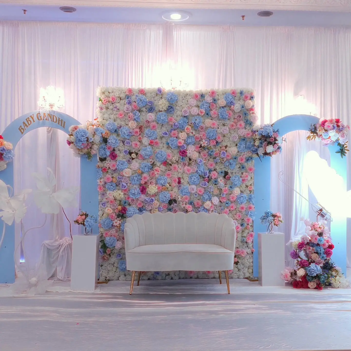 Luxury floral baby shower backdrop with pastel theme and couch
