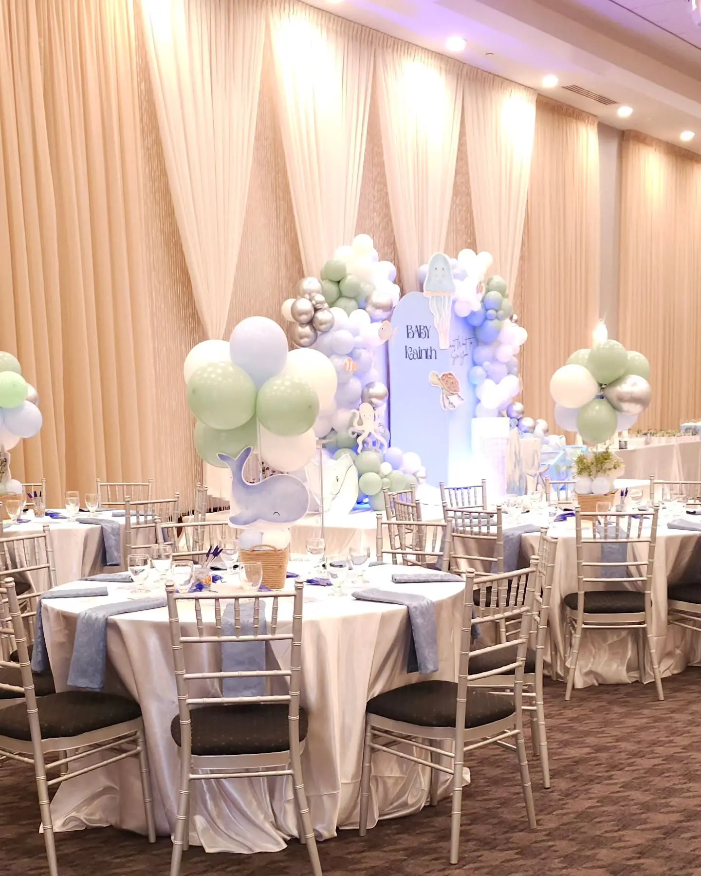 Under the sea baby shower backdrop with turtle and jellyfish cutouts