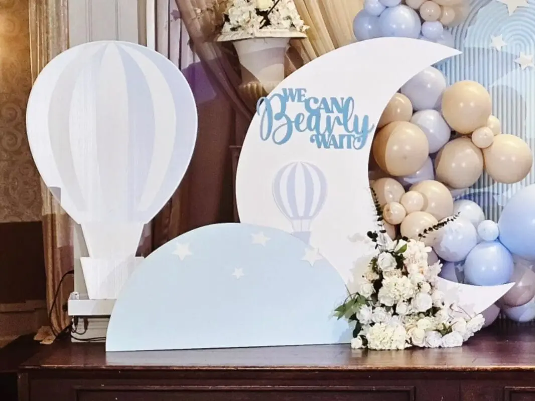 Light blue and cream bridal shower decor with moon, hot air balloon props, star cutouts, and “We Can Bearly Wait” theme in Brampton