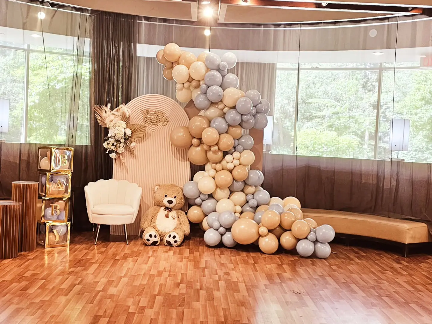 Elegant bridal shower balloon garland with beige and grey tones, styled with a backdrop and florals in Brampton