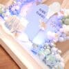 Jellyfish, turtle, and coral props on baby shower backdrop